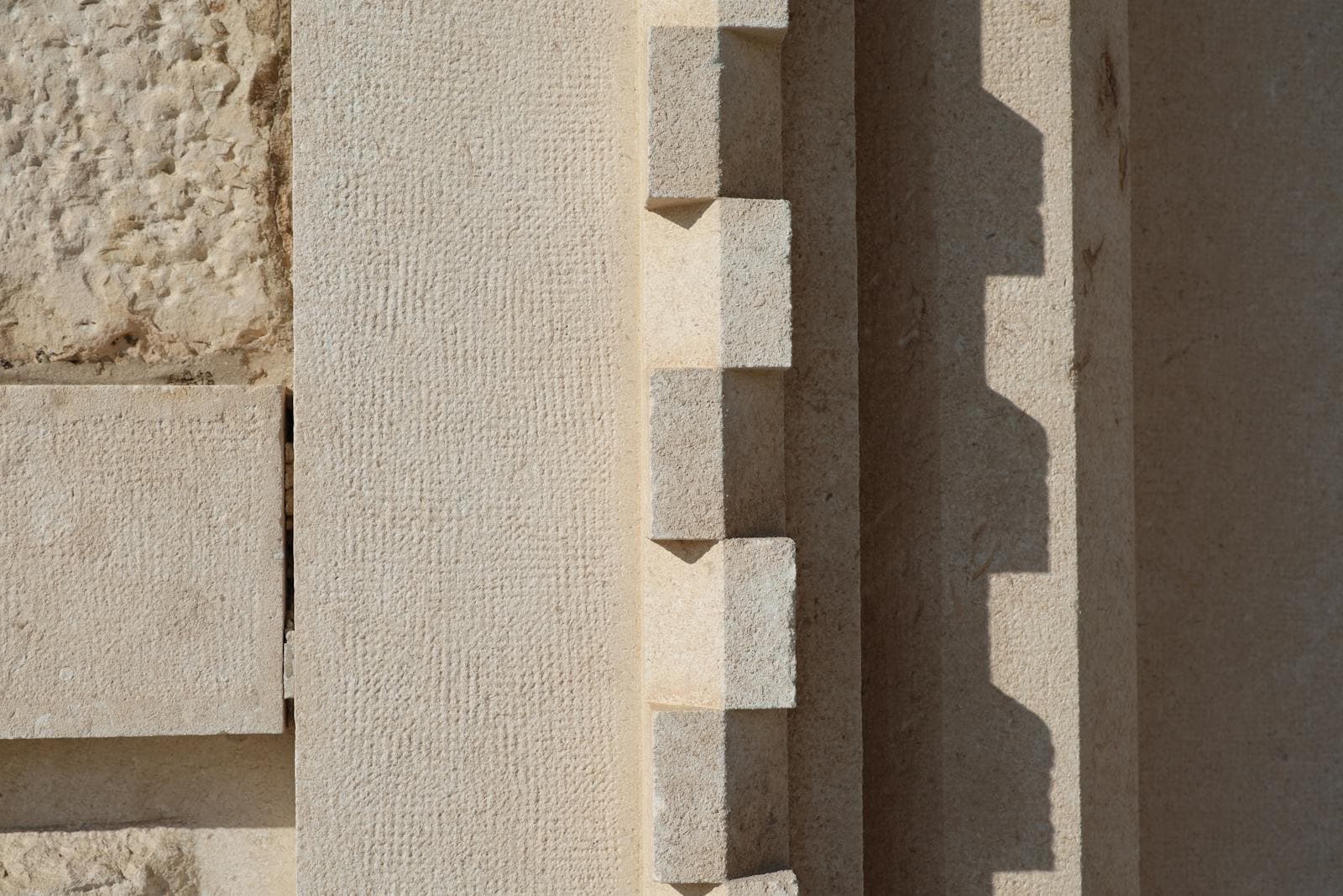 Textured stone wall with geometric shadows